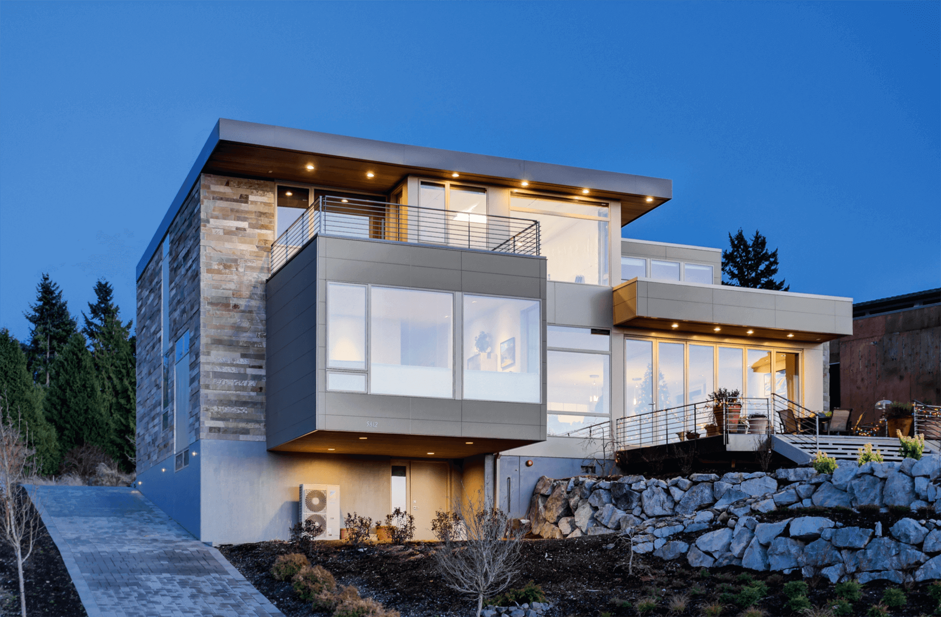 Exterior view of modern residential building with fiber cement panels and large windows