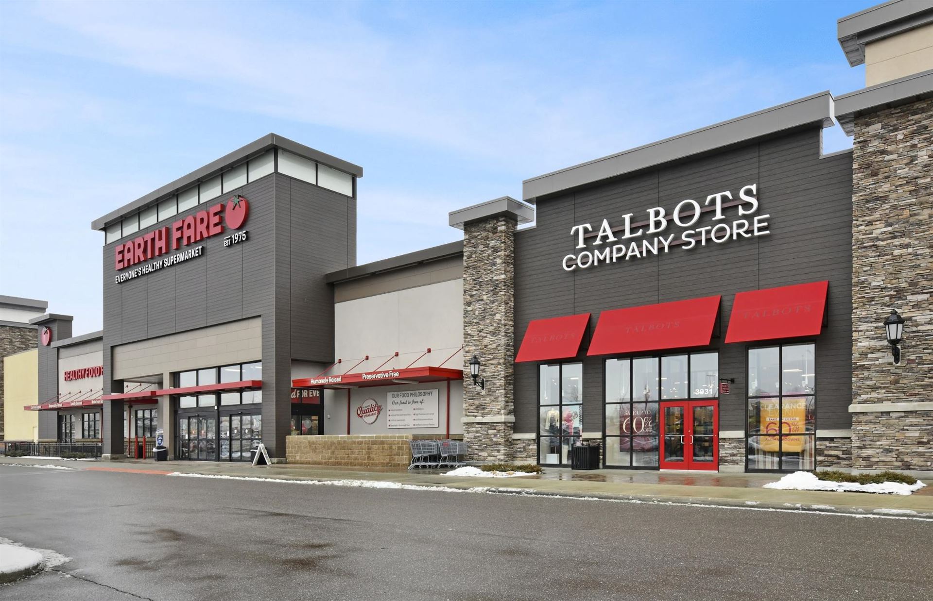 Nichiha-Illumination-VinatageWood-Commercial, Shopping center store fronts of a Earth Fare and Talbots that use Nichiha&rsquo;s VintageWood panels in the color Bark