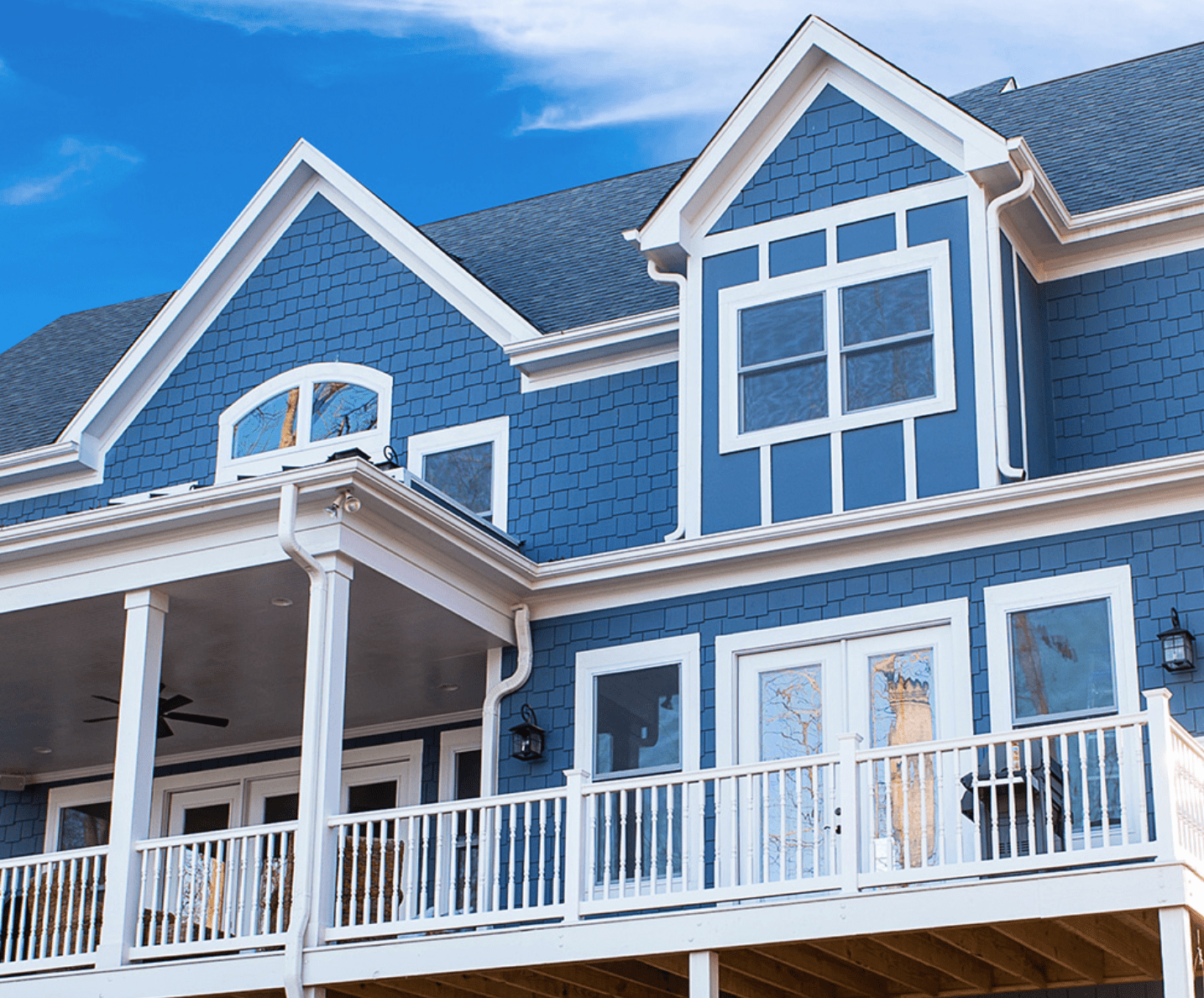 Exterior view of modern residential building with fiber cement panels and large windows