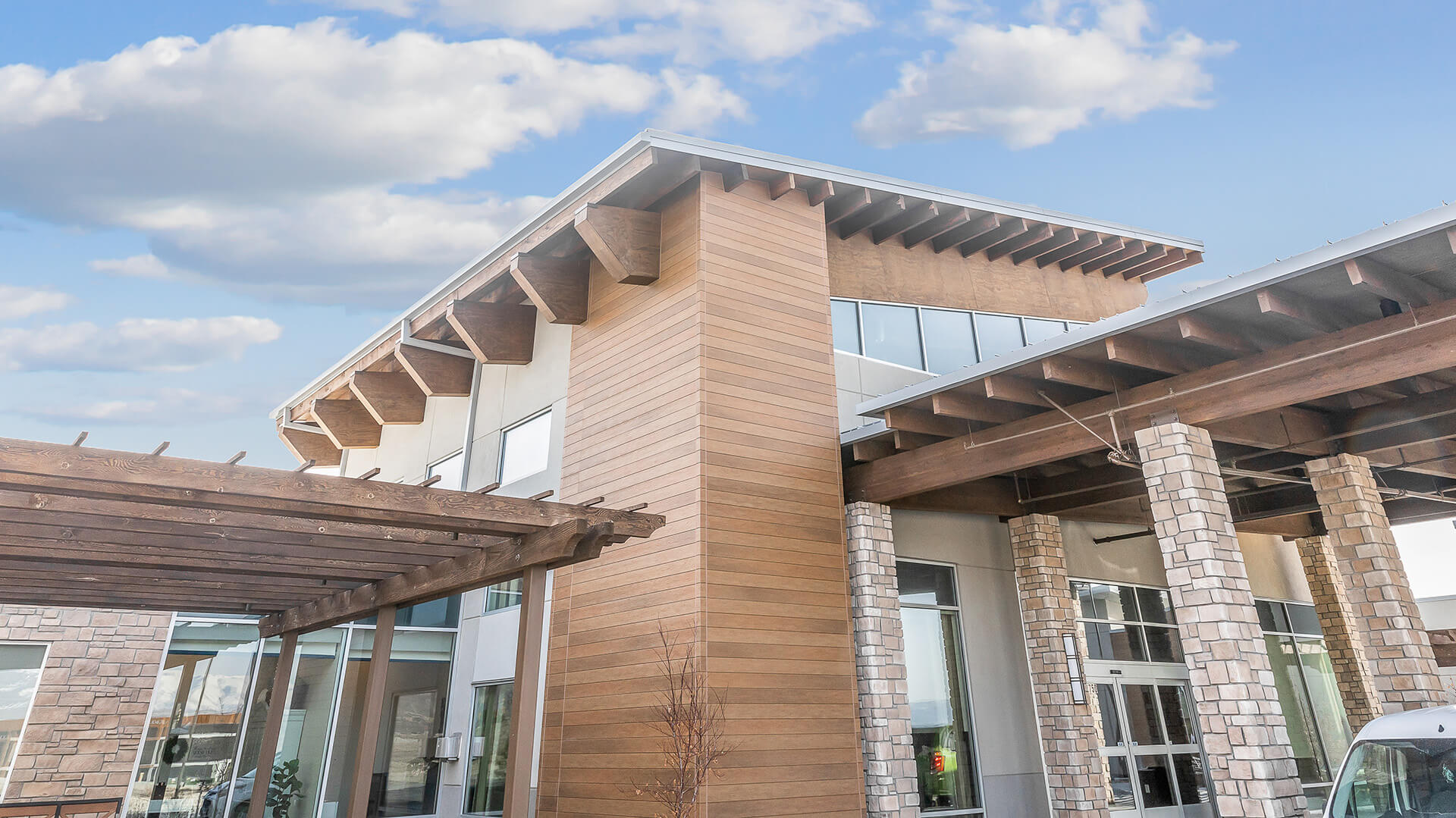 Nichiha-VintageWood-Cedar-Commercial, Corner of commercial building that features Nichiha&rsquo;s VintageWood panels in the color Cedar