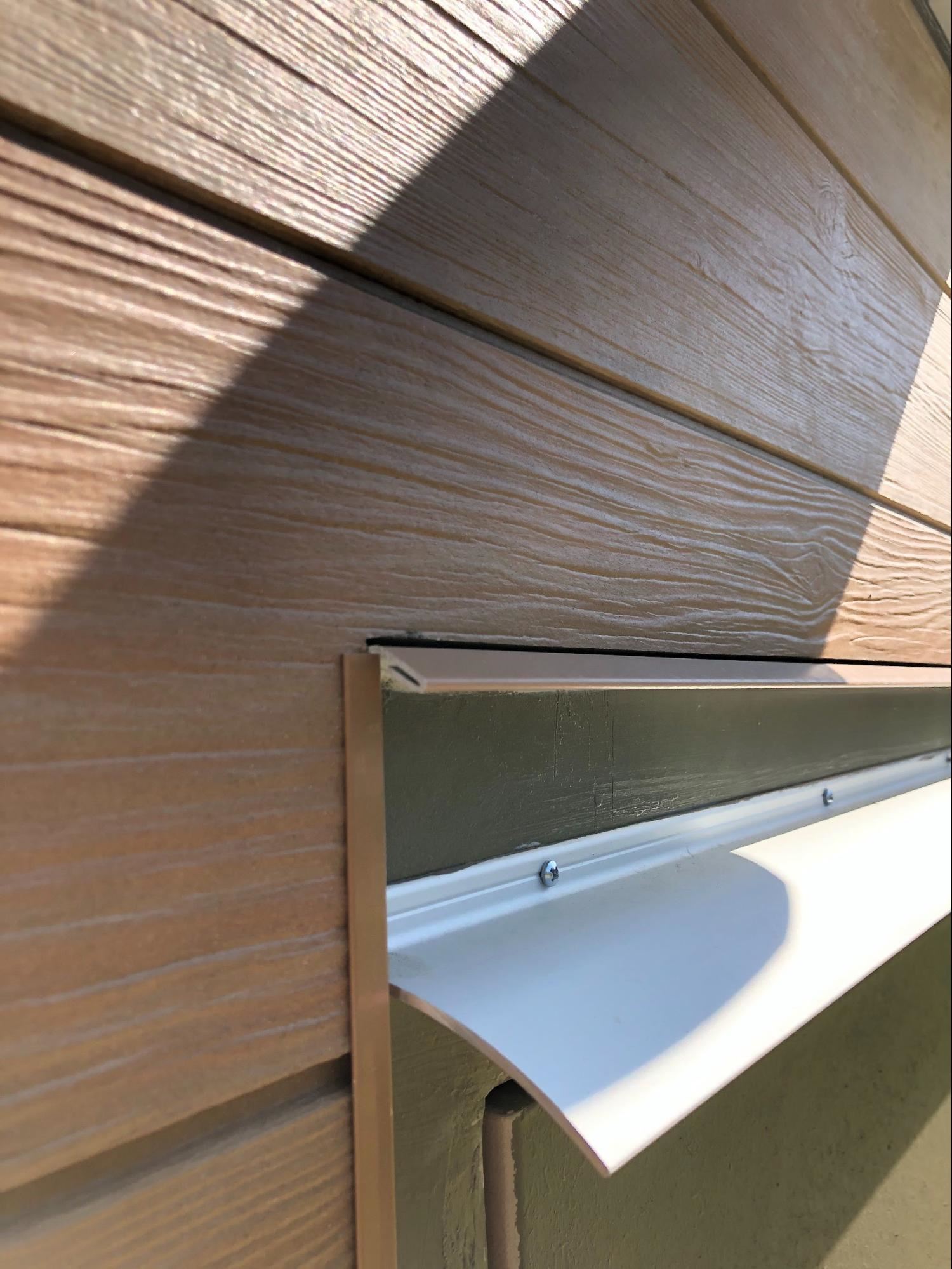 Modern building showcasing fiber cement panels with wood, brick or stone aesthetic
