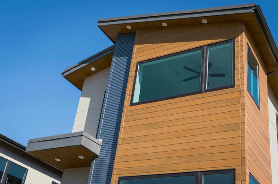 Exterior view of modern residential building with fiber cement panels and large windows