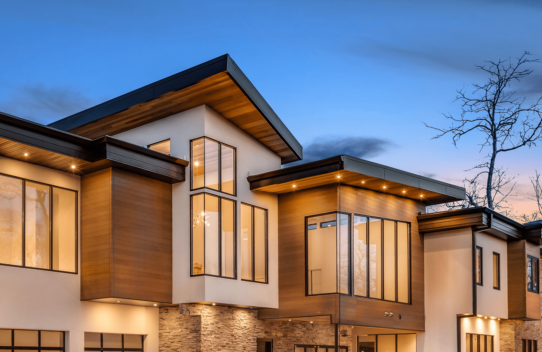 Exterior view of modern residential building with fiber cement panels and large windows