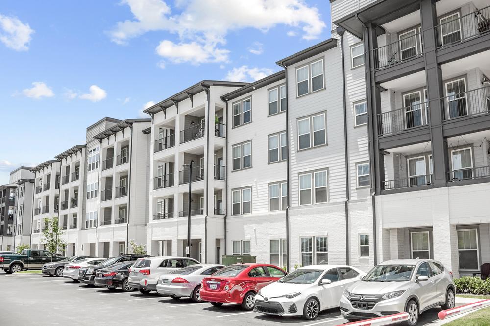 A multifamily apartment complex with white and dark gray Nichiha fiber cement cladding.