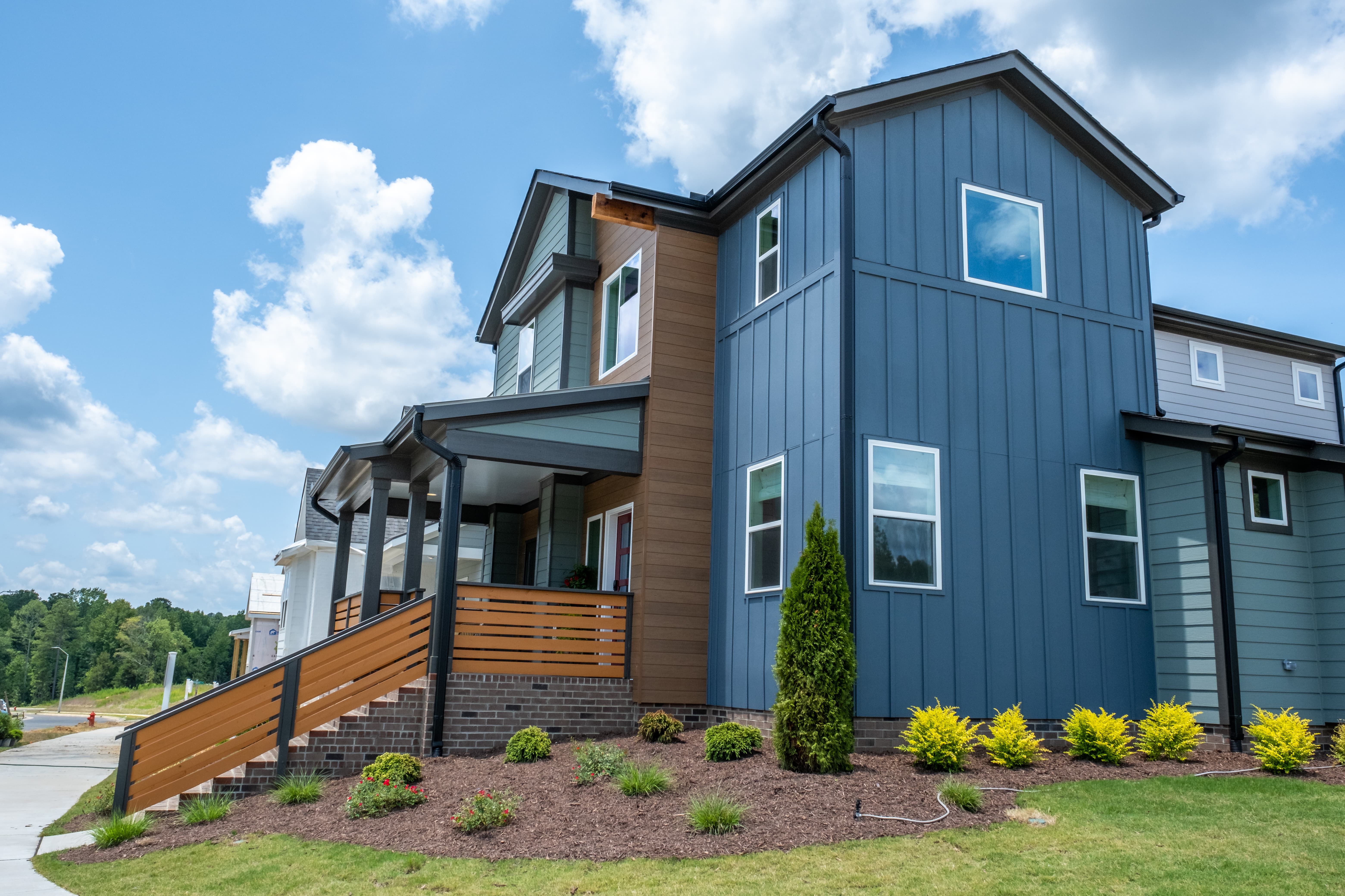 Exterior view of modern residential building with fiber cement panels and large windows