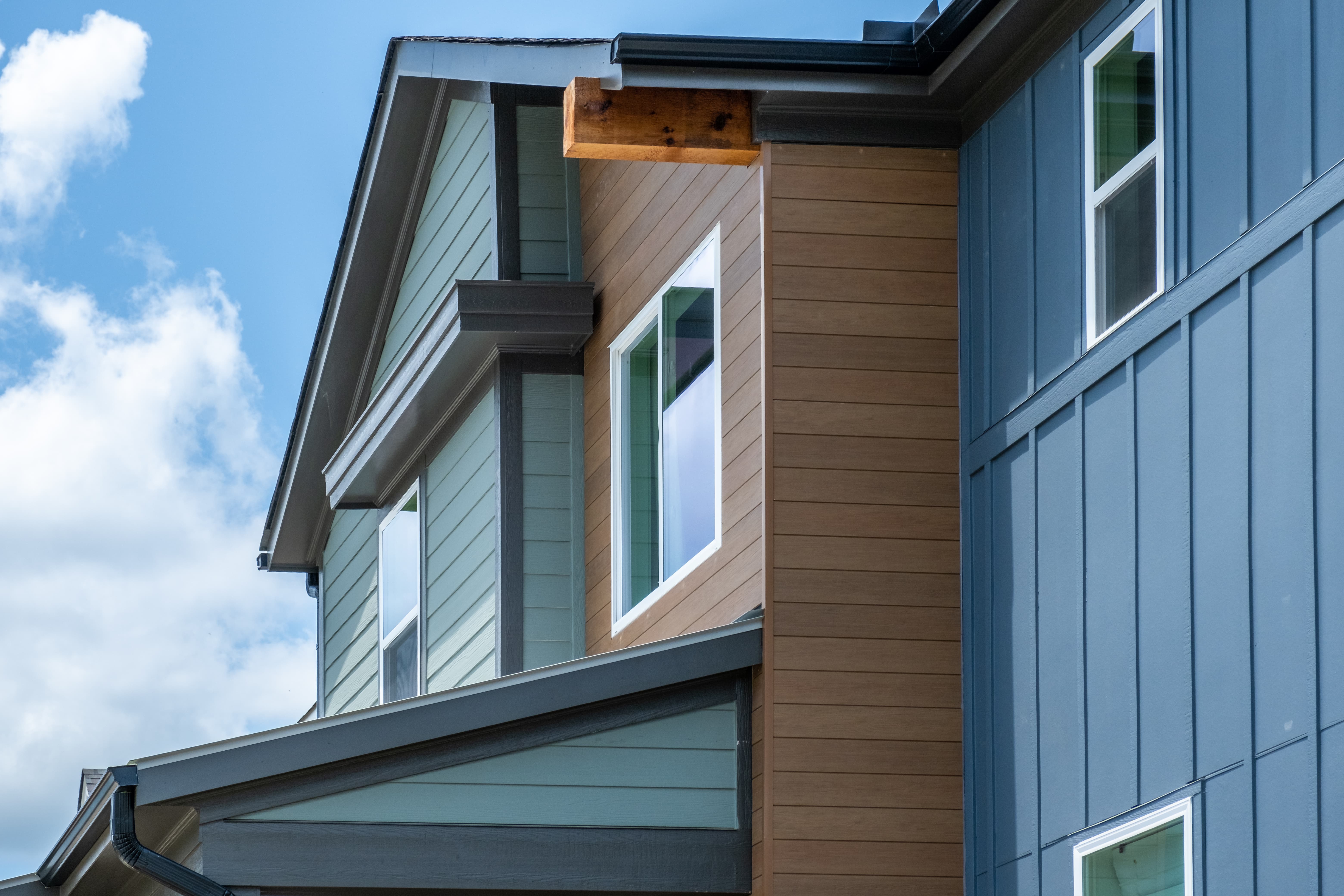 Exterior view of modern residential building with fiber cement panels and large windows