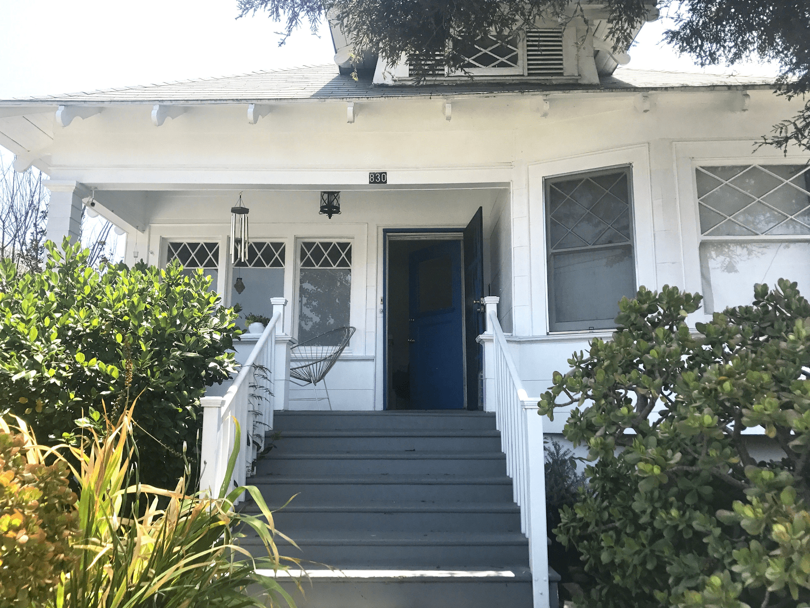 Before photo of Rosa&rsquo;s home, taken from the front looking up the steps with the entry door open.