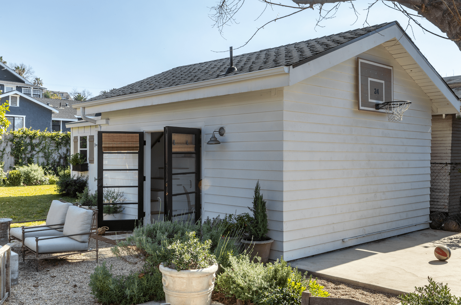 Image of the new guest house with the double doors open and basketball hoop attached to the side of the building