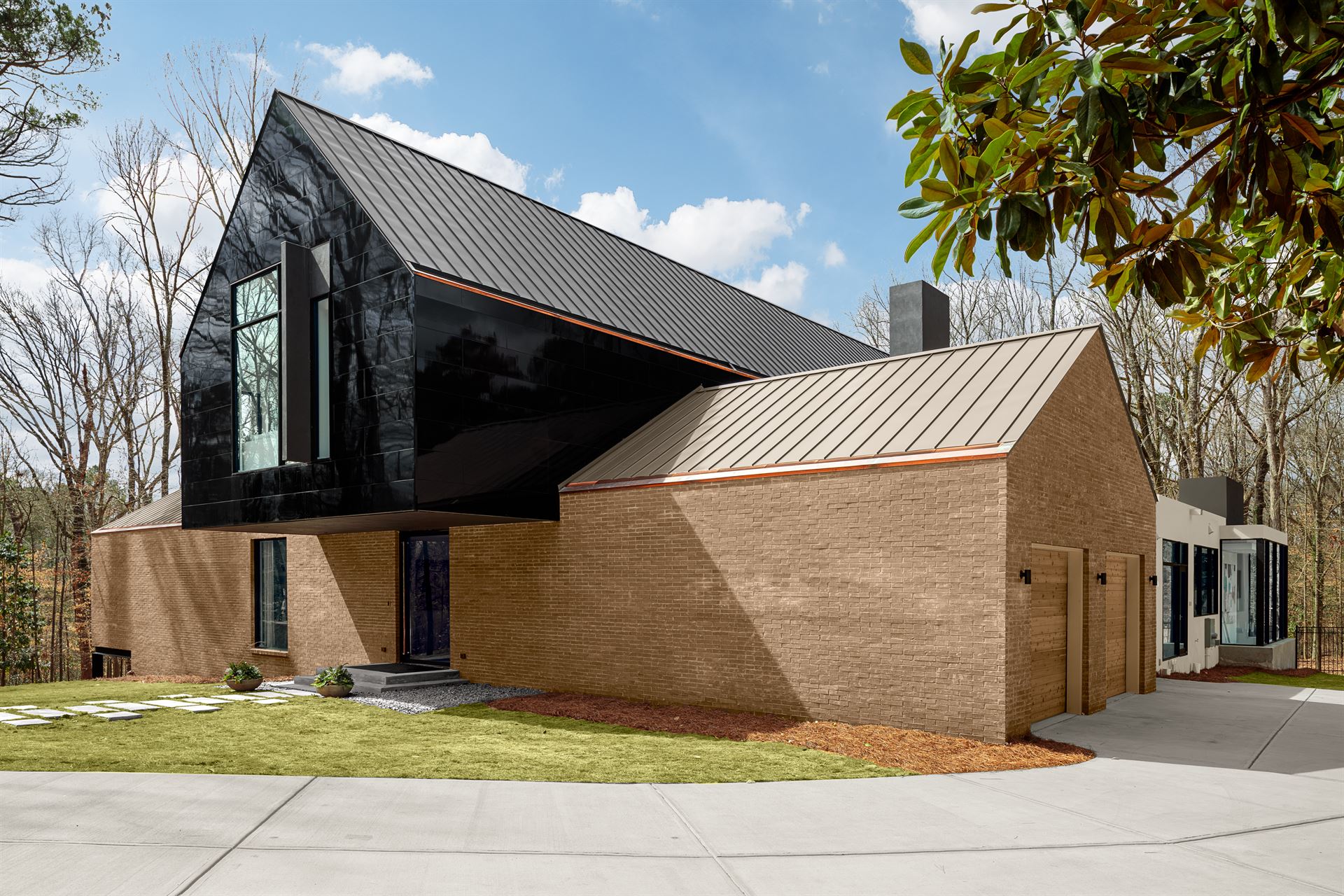 Exterior shot of Atlanta Symphony Orchestra Designer Showhouse with reflective, black Miraia panels