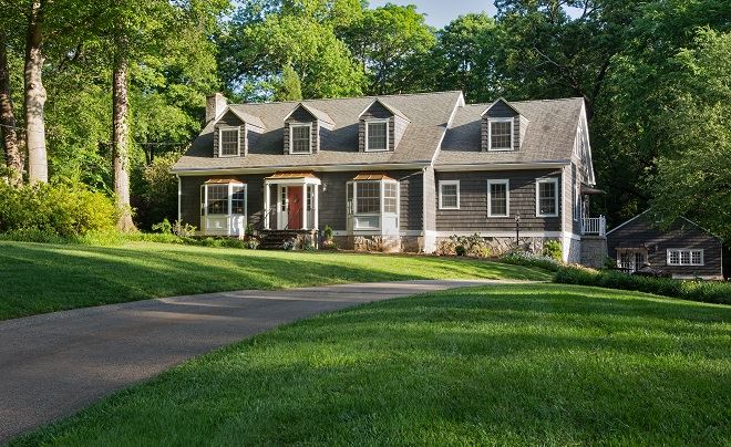 Exterior view of modern residential building with fiber cement panels and large windows