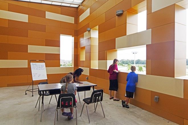 Exterior view of a building featuring Nichiha fiber cement panels and modern design