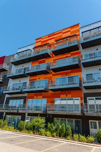 Exterior view of Marketplace Lofts building with fiber cement panels and expansive windows