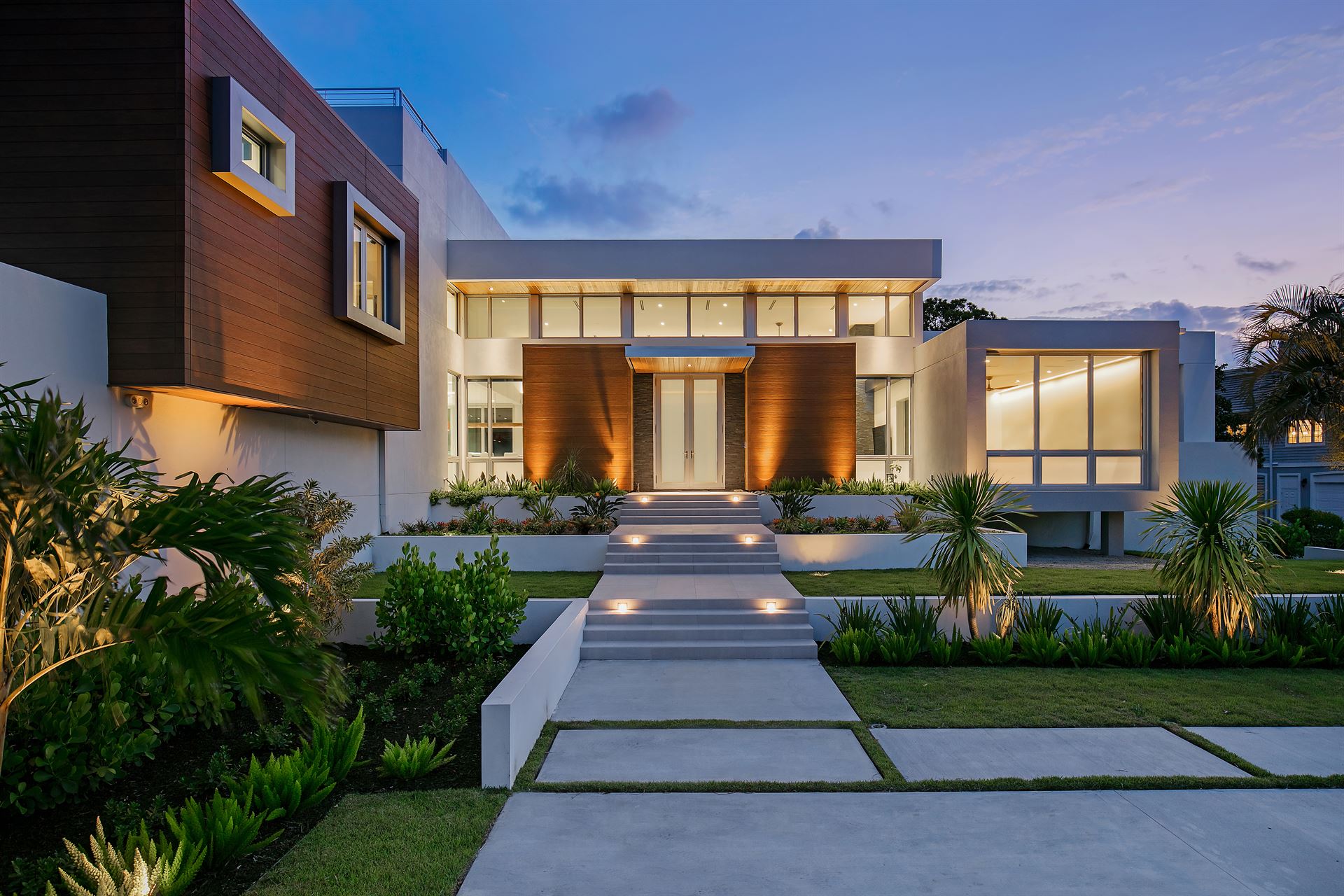 A look up towards the front entrance of a modern home, featuring lots of windows and VintageWood fiber cement siding.