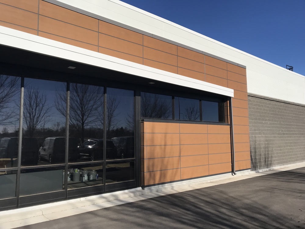 Nichiha&rsquo;s RiftSawn fiber cement cladding in pecan on the walls of a Budget Blinds storefront.