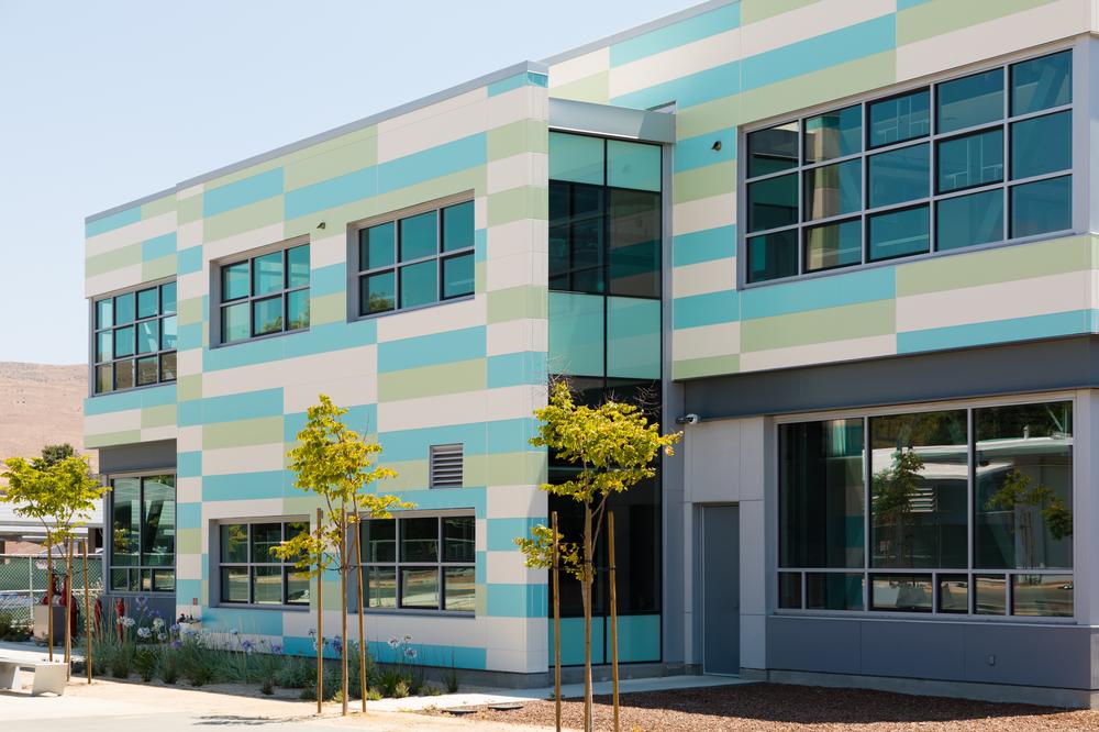 Tennyson High School with Nichiha&rsquo;s Illumination panels in white, blue and green.