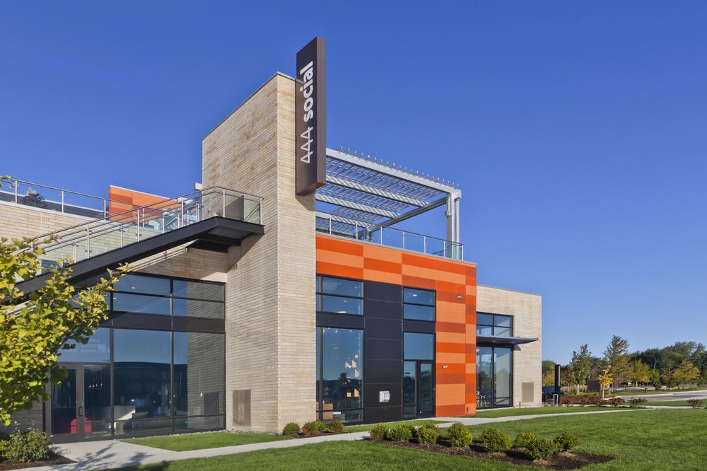 444 Social apartment complex with an L-shaped section of custom orange fiber cement cladding.