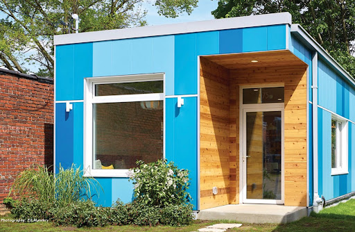 Exterior view of modern residential building with fiber cement panels and large windows
