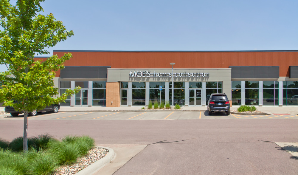 A close-up of the strip mall at South Lorraine Place. Moe&rsquo;s home collection storefront utilizes three different textures of Nichiha&rsquo;s fiber cement cladding.