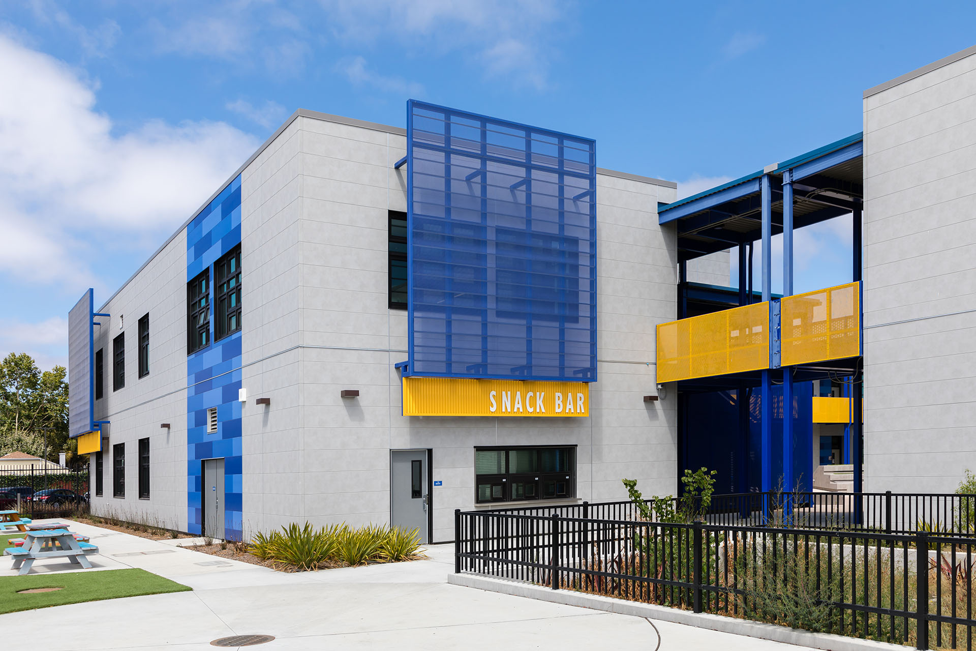 Outside view of Madison Park Academy with  IndustrialBlock and blue and yellow Illumination panels from Nichiha