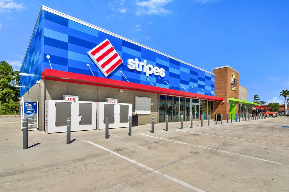 Stripes storefront with red awning and siding in multiple shades of blue.