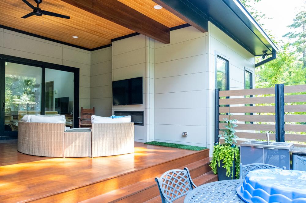 Nichiha&rsquo;s fiber cement siding in white is being used on a back porch with an overhanging roof.