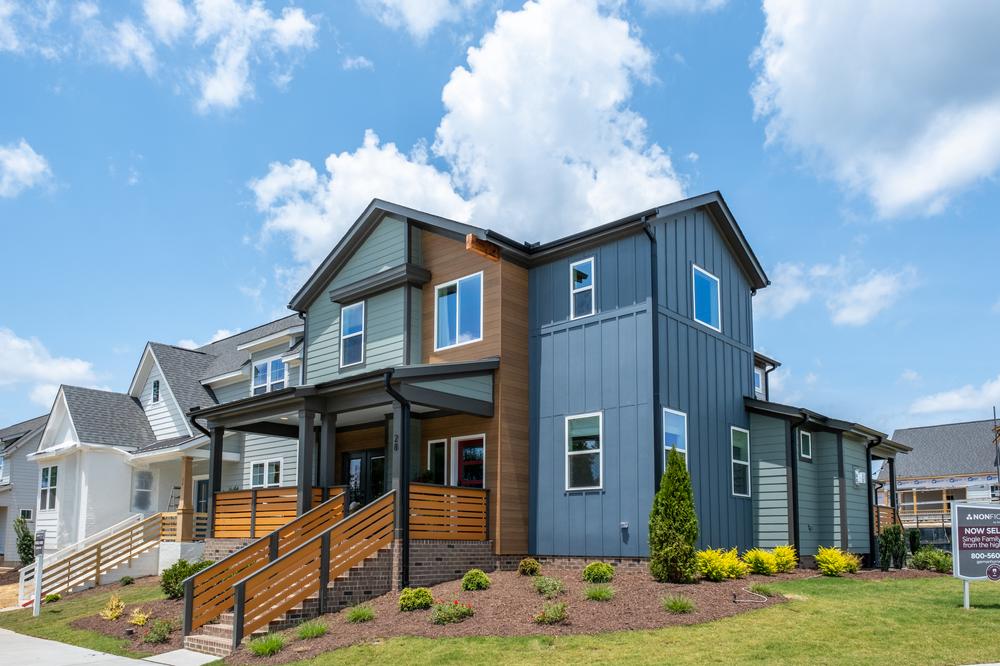 A blue, wood-toned, and dark brown home utilizing Nichiha&rsquo;s fiber cement siding.