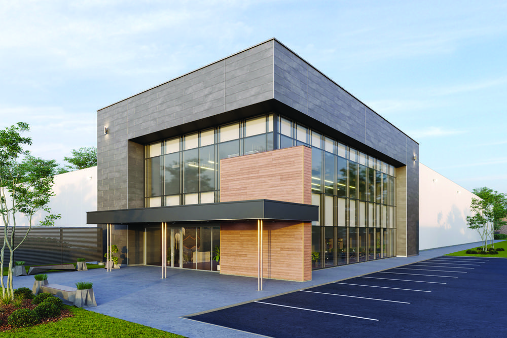 The entryway of a modern building is shown with large glass windows, wood and concrete cladding on the exterior.