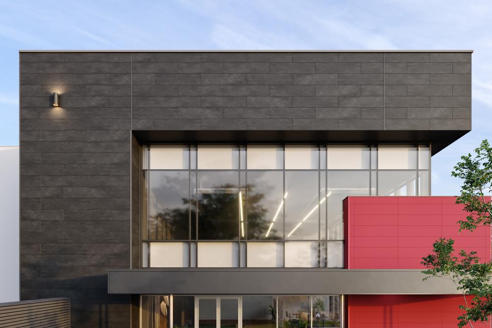 A modern building is shown with large glass windows and concrete cladding on the exterior.