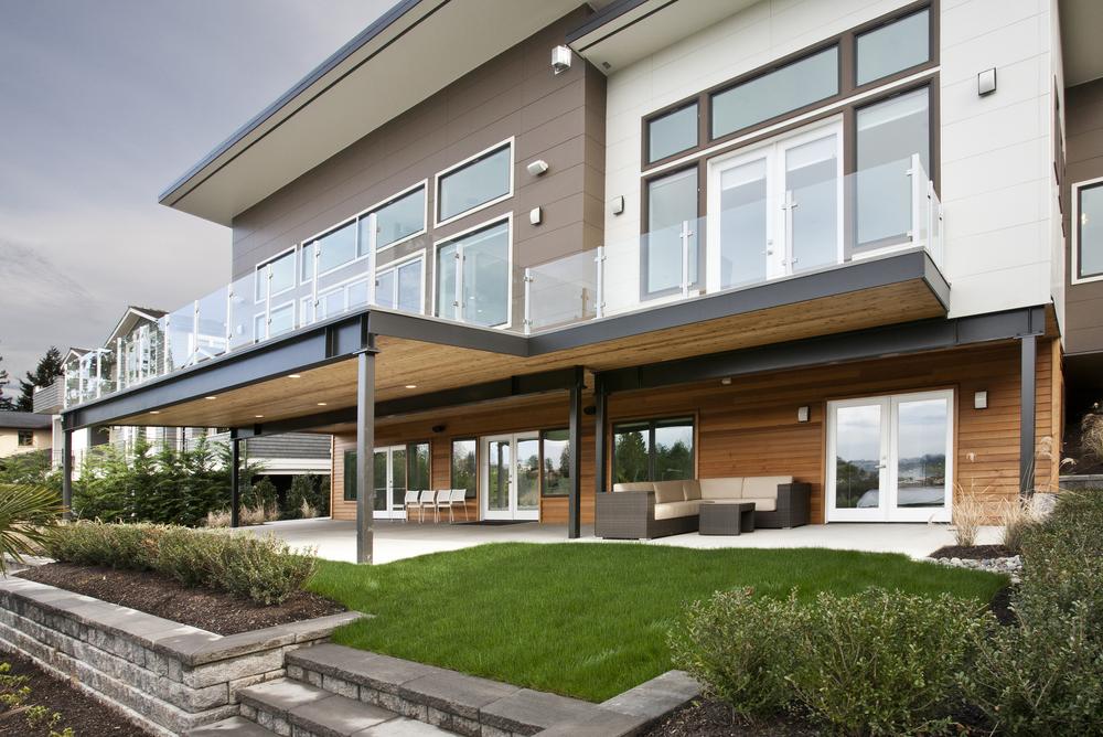 This large home has large areas for entertaining. There are two floors, both with large windows and glass doors to overlook the outdoors.