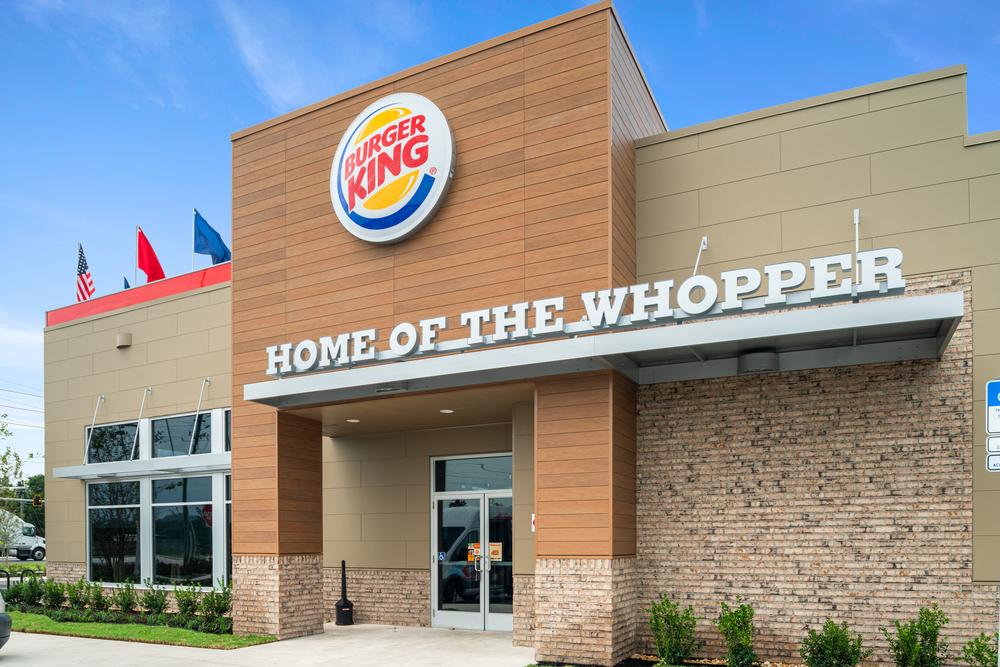 A Burger King restaurant has fiber cement siding. There is a &ldquo;Home Of The Whopper&rdquo; sign above the entrance.