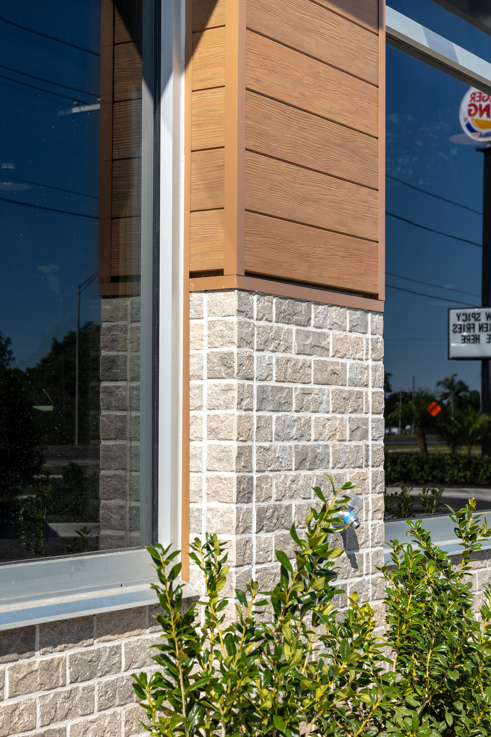 Exterior of fast food restaurant with fiber cement panels and signage