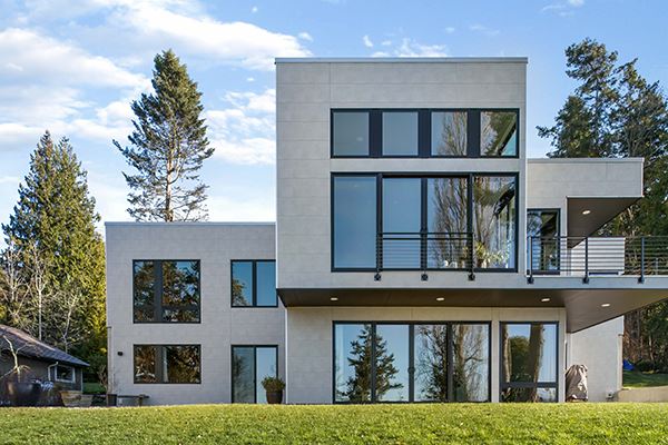 A modern style home featuring gray, concrete-texture fiber cement siding