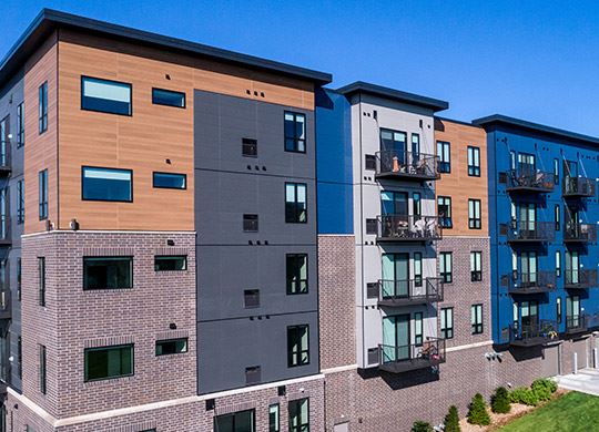 Exterior view of modern residential building with fiber cement panels and large windows