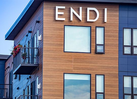 Exterior view of modern residential building with fiber cement panels and large windows