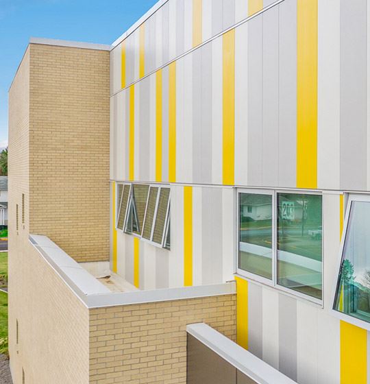 Exterior view of a building featuring Nichiha fiber cement panels and modern design