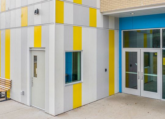 Exterior view of a building featuring Nichiha fiber cement panels and modern design