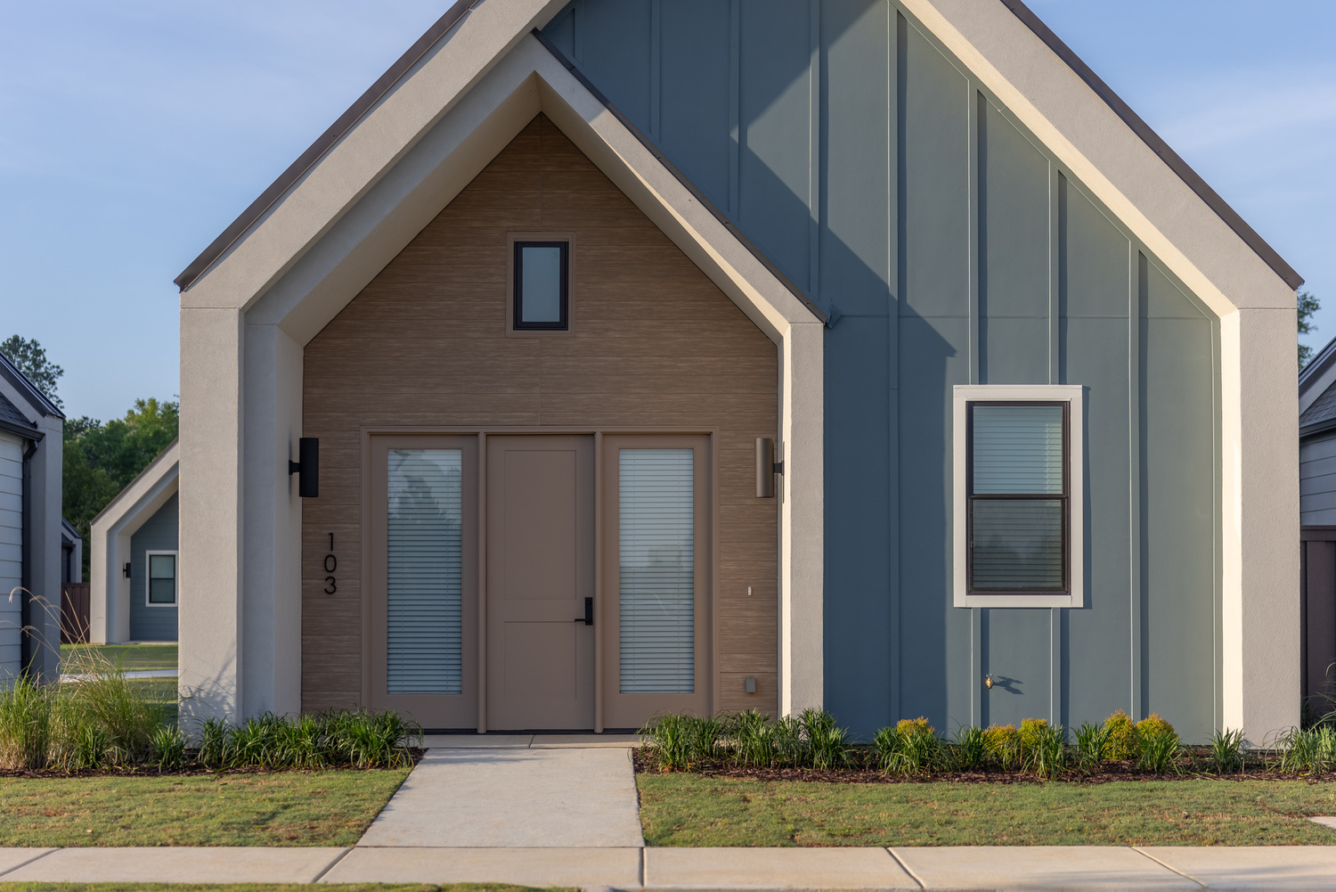 Exterior view of a building featuring Nichiha fiber cement panels and modern design