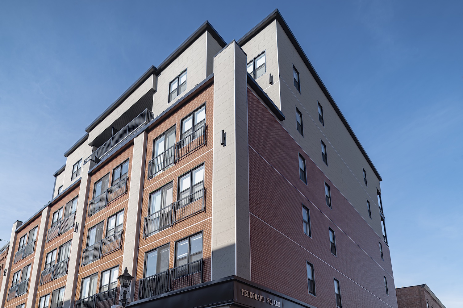 Exterior view of a building featuring Nichiha fiber cement panels and modern design