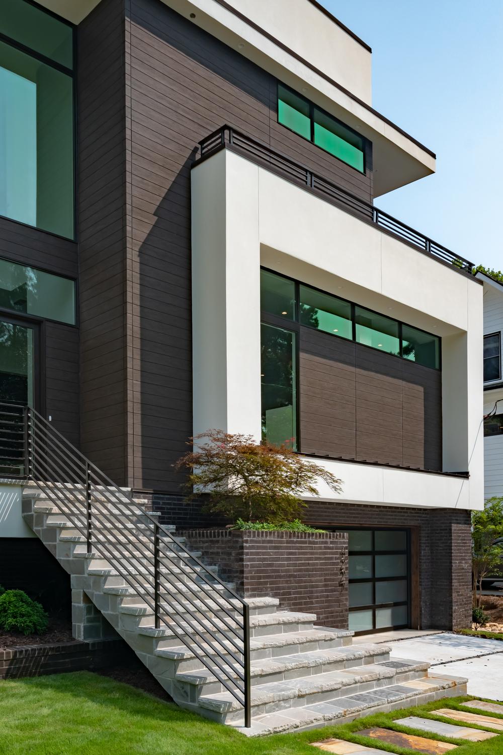 Side view of a contemporary house with wood-textured and concrete-style fiber cement siding.