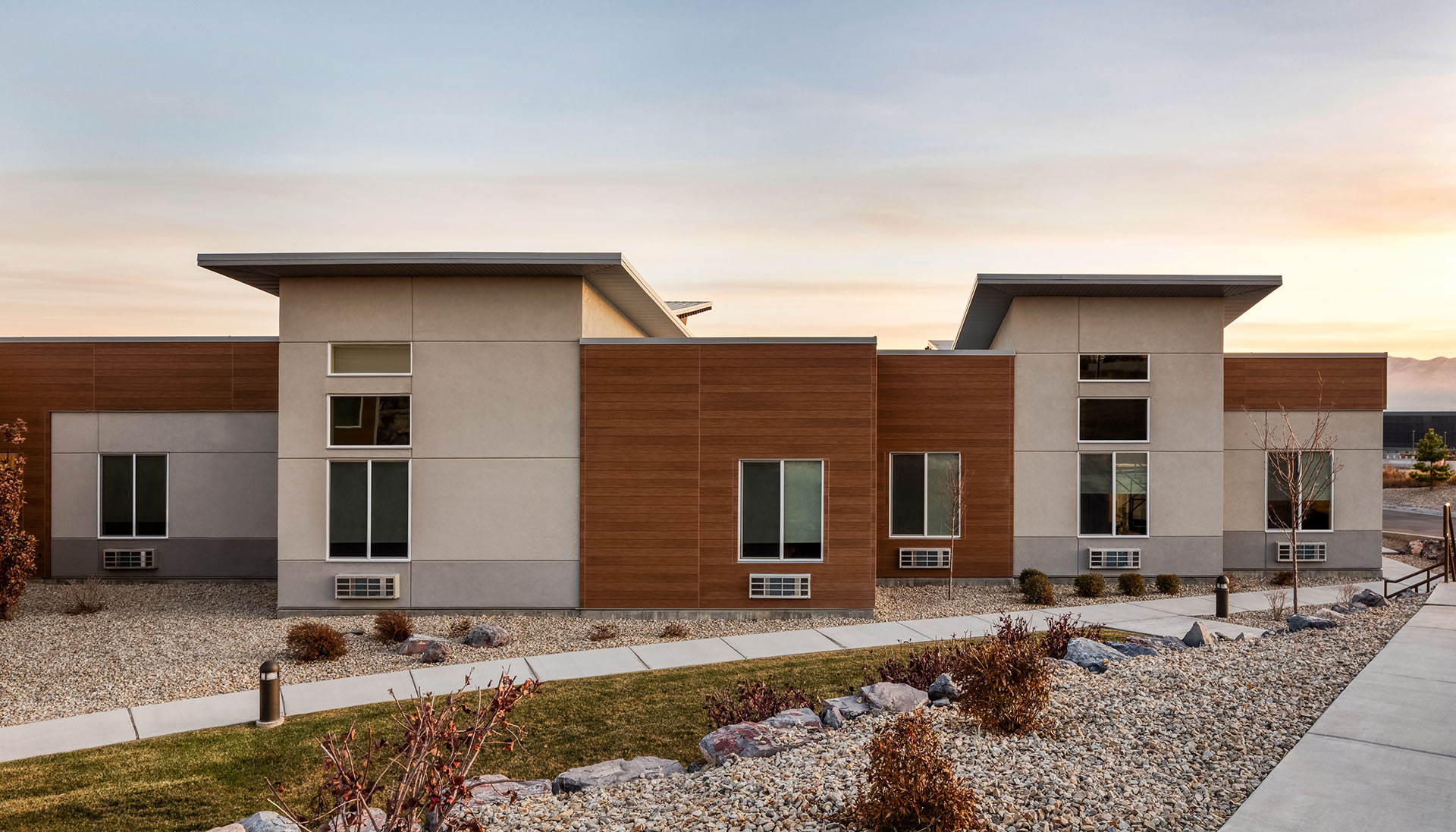 exterior of Lehi Skilled Nursing building in the desert with beautiful sunset