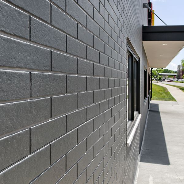 Looking down a wall of Nichiha ModernBrick panels in black